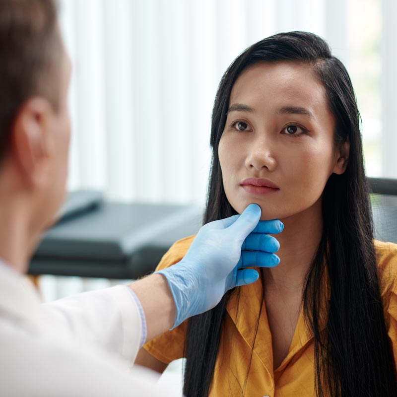 A healthcare professional examines a patient for an ENT procedure in Surprise, AZ.
