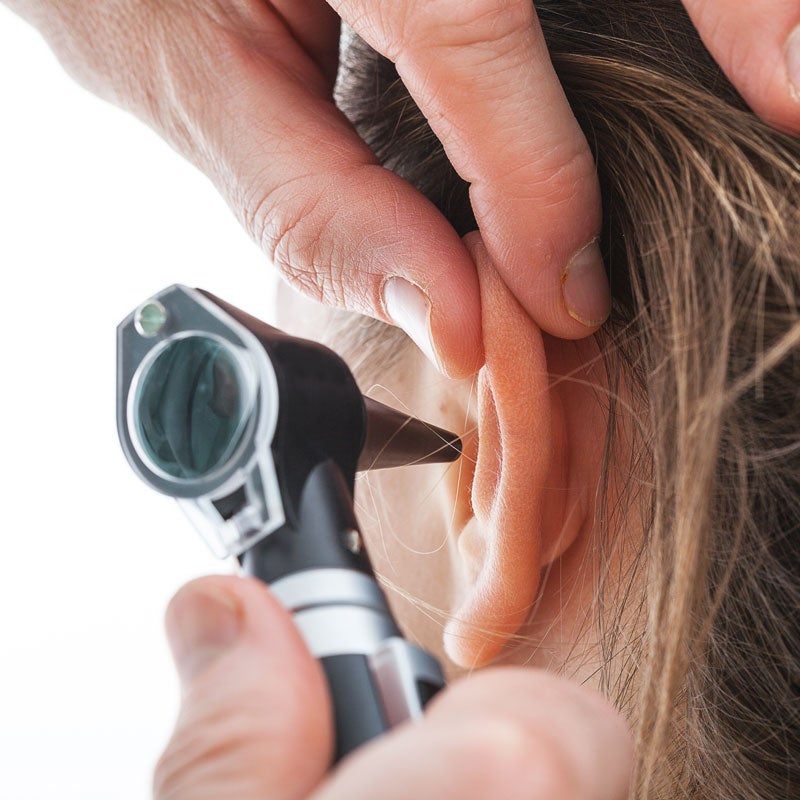 Doctor examining a patient's ear for infections in Surprise, AZ