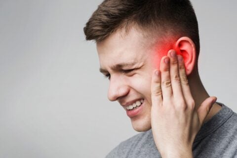 Man suffering from ear pain due to ear infection in Surprise, AZ