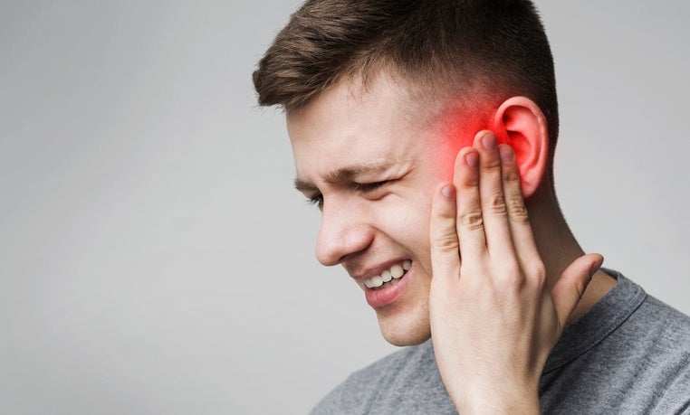 Man suffering from ear pain due to ear infection in Surprise, AZ